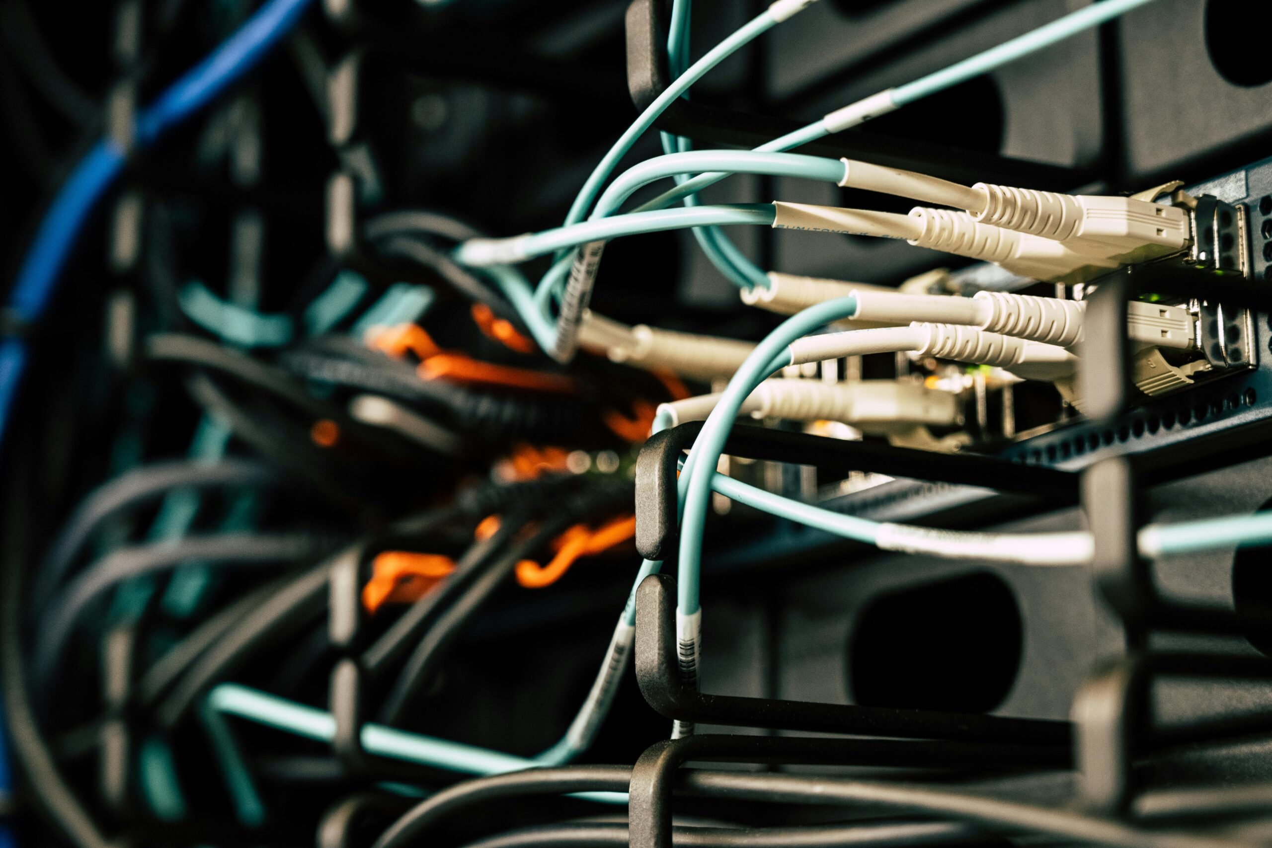 Fiber optic cables connected to network switch in server rack